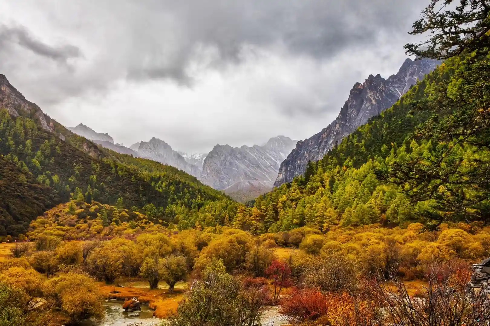Autumn colors settle across a valley landscape.